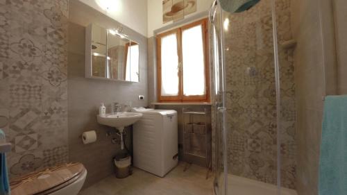 a bathroom with a toilet and a sink and a shower at Conero Guest House in Numana
