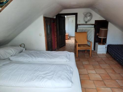 a bedroom with two beds and a chair at Haus Wartenberg in Salzburg