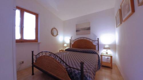 a bedroom with a bed and a window at Conero Guest House in Numana
