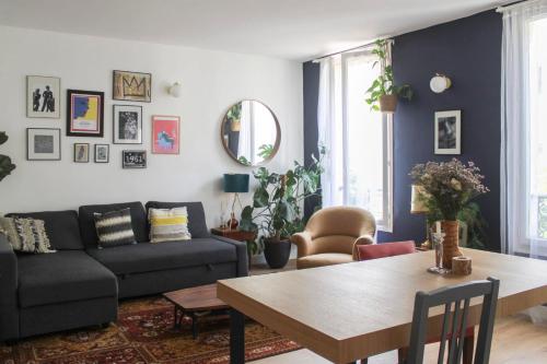 a living room with a couch and a table at Luminous cocoon in Aubervilliers in Aubervilliers