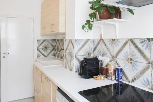 a kitchen with a sink and a microwave at Luminous cocoon in Aubervilliers in Aubervilliers
