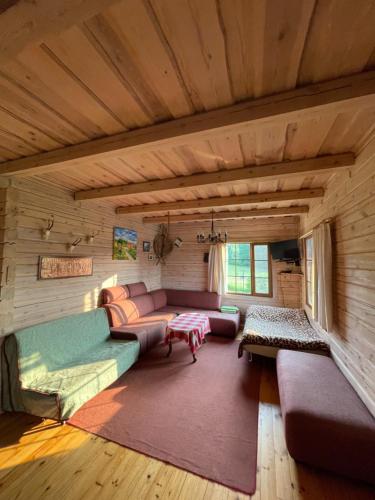 a living room with a couch and a table at Sodyba Duobys in Alanta