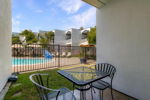 a patio with a table and chairs and a pool at Best Western Plus Wine Country Inn & Suites in Santa Rosa
