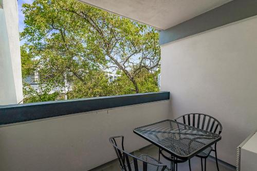 a balcony with a table and chairs and a window at Best Western Plus Wine Country Inn & Suites in Santa Rosa