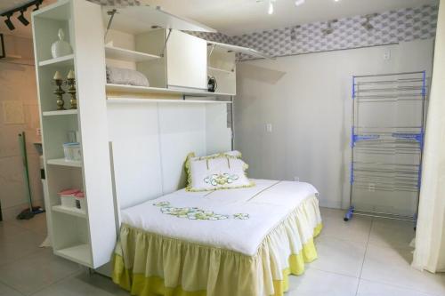 a bedroom with a bed and shelves in a room at Apto funcional ao lado da Universidade Catolica in Taguatinga
