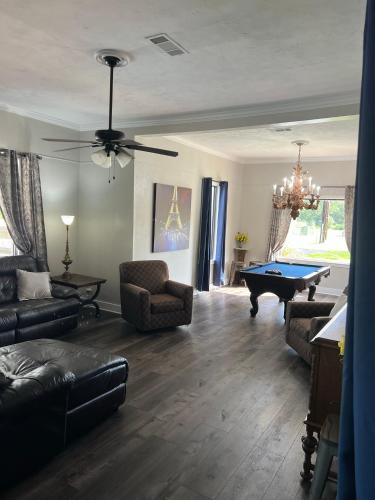 a living room with a pool table in it at Train Depot - 3 BR Home with Pool, Sand Volleyball & Pool Table in Montgomery