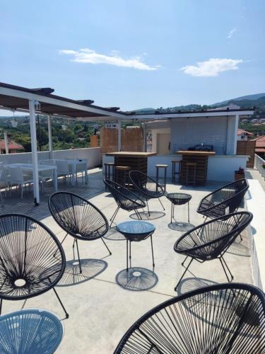 a group of chairs and tables on a patio at ThalaSEA Apartments in Chrani