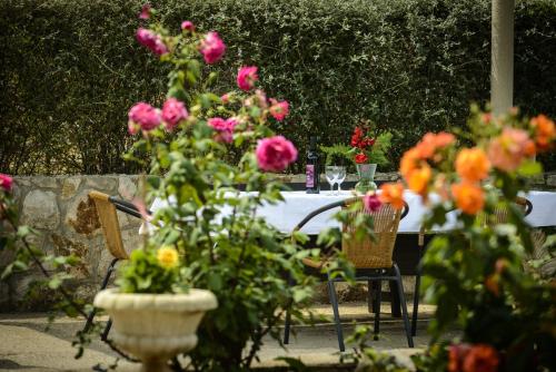 a table with glasses of wine and flowers on it at Villa Mali Raj in Zaton
