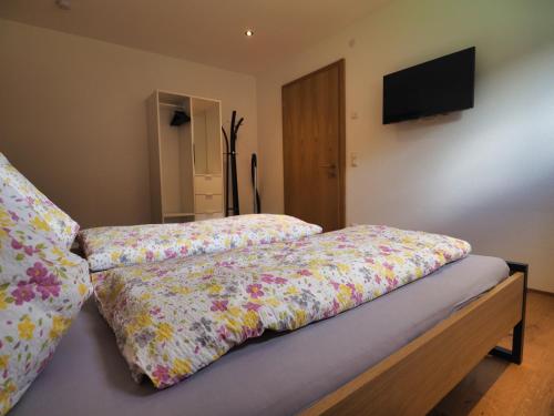 a bed with two pillows on top of it at Kanistraum Appartement in Schoppernau
