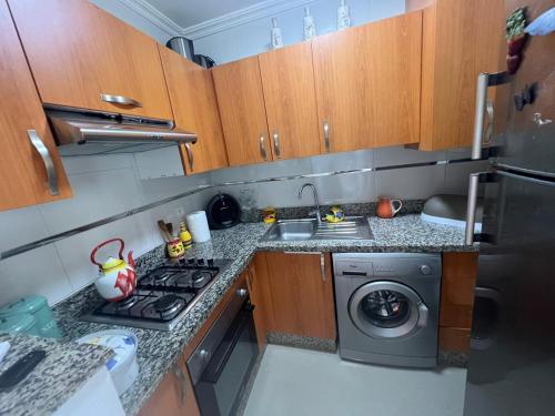a small kitchen with a stove and a dishwasher at Asilah Marina Golf in Asilah