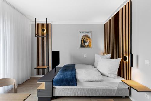 a bedroom with a bed with a wooden headboard at Nena Apartments Berlin Adlershof in Berlin