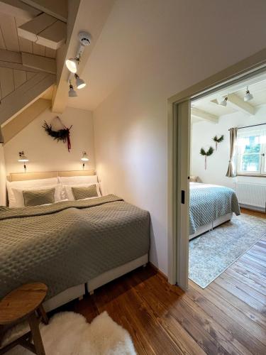 a bedroom with a large bed and a window at Apartmány v Beskydech in Frenštát pod Radhoštěm