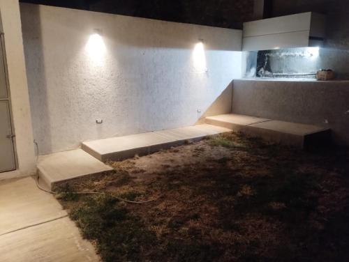 a room with two beds in a room with grass at Duplex en barrio privado in Mendoza
