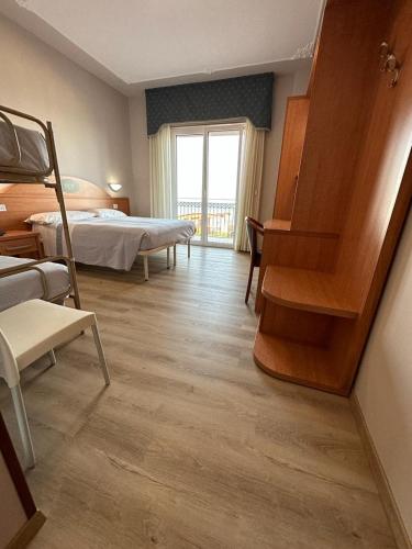 a bedroom with a bed and a staircase in it at Hotel Costa Verde in Pineto