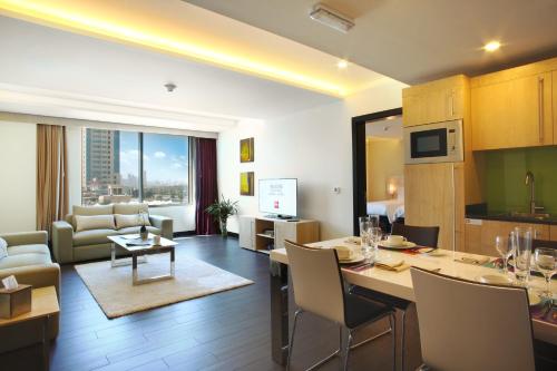 a kitchen and living room with a table and chairs at ibis Kuwait Salmiya in Kuwait