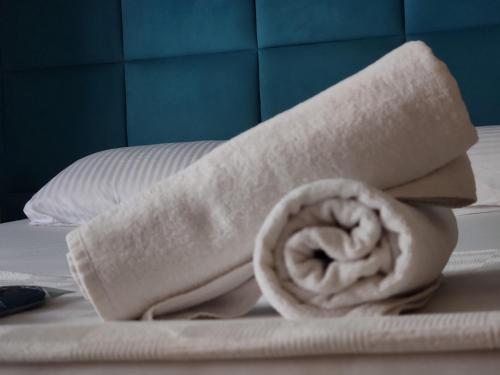 a rolled up towel on top of a bed at Corner Palace Levent in Istanbul