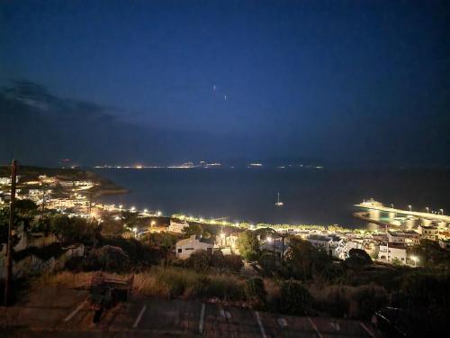a city at night with a cruise ship in the water at Stella's Houses in Agia Pelagia Kythira