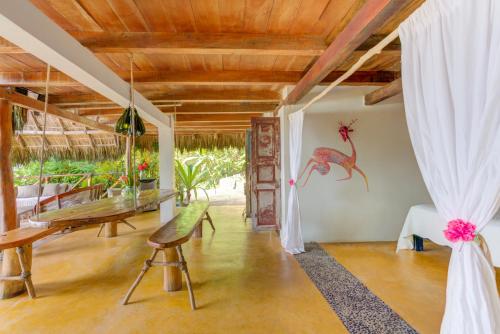 a living room with a wooden ceiling and a table at Casitas Maraika in Puerto Vallarta