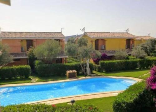 a house with a swimming pool in a yard at Villa Juniperus Porto Pino in SantʼAnna Arresi