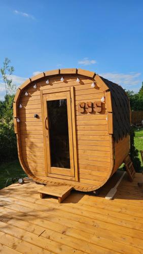 a wooden sauna sitting on top of a wooden deck at Browarówka in Łomnica
