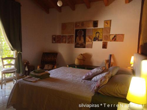 a bedroom with a bed with two legs laying on it at B&B Fiadora Artist House in Decimoputzu