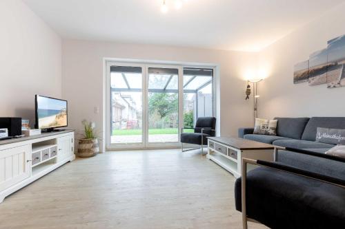 a living room with a couch and a tv at Alte Waescherei _9462_ in List