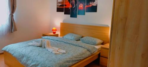 a bedroom with a bed with two pairs of towels on it at Sleepy Paradise Plitvice in Rakovica