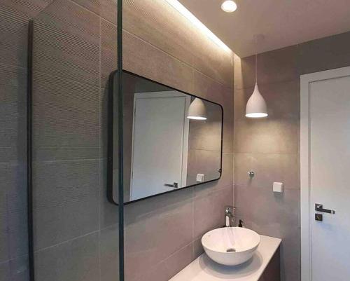 a bathroom with a sink and a mirror at Savvina's residence in Rhodes Town