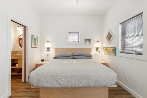 a bedroom with a large bed in a white room at Hotel Folly with Marsh and Sunset Views in Folly Beach