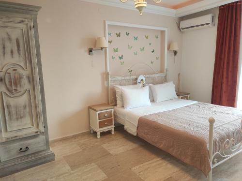 - une chambre avec un lit blanc et une table de nuit dans l'établissement Apartment Petrovac, à Petrovac na Moru