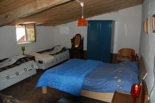 a bedroom with two beds and a blue bed at Gite Juste Confortable in Fleurey-lès-Lavoncourt