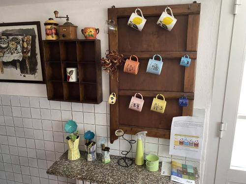 a kitchen with a counter with a bunch of cups at Casa Di Campagna tra borghi e castelli in Borgo a Buggiano