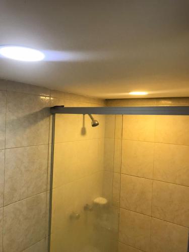 a shower with a glass door in a bathroom at Habitación Súper Confortable in Medellín