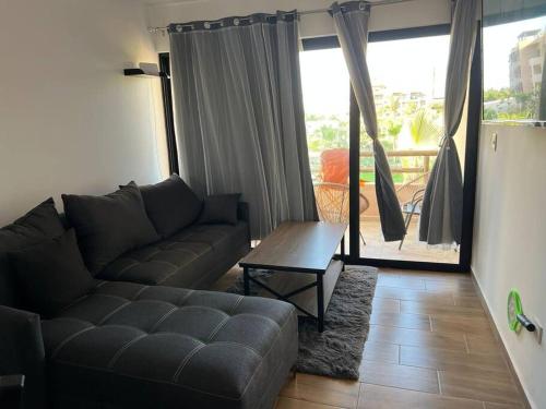 a living room with a couch and a table at Ancla 201 Departamento Familiar in Altata