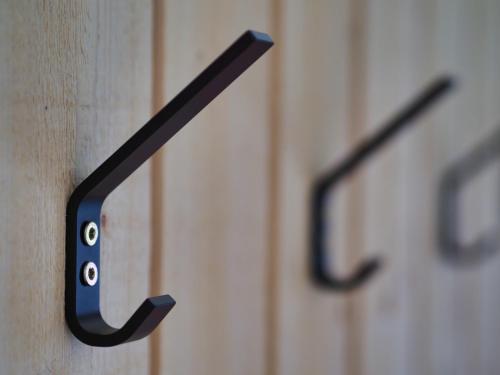 a pair of black handles on wooden cabinets at Kanistraum Appartement in Schoppernau