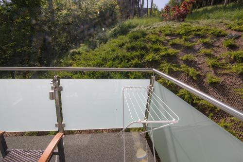 a chair sitting on a metal railing next to a hill at Hotel Gabriel in Keutschach am See