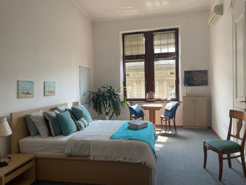 a bedroom with a bed and a desk and a window at AVANTI Family in Krakow