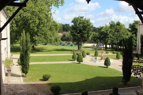 a view of a park with trees and bushes at Domaine des Chais in Thénac