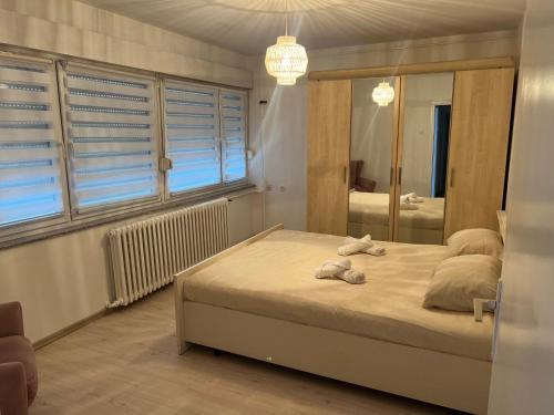 a bedroom with a bed with towels on it at Apartman Krasota in Banja Luka