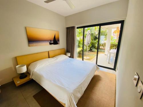 a bedroom with a bed and a large window at Choisy Les Bains D2 in Mont Choisy