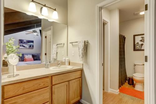 a bathroom with a sink and a toilet and a mirror at Private condo steps from ski lift minutes to lake in Stateline
