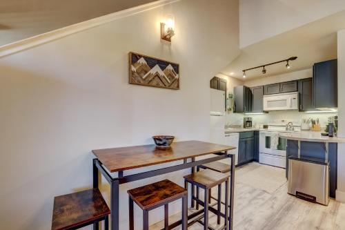 a kitchen with a wooden table and some chairs at Private condo steps from ski lift minutes to lake in Stateline