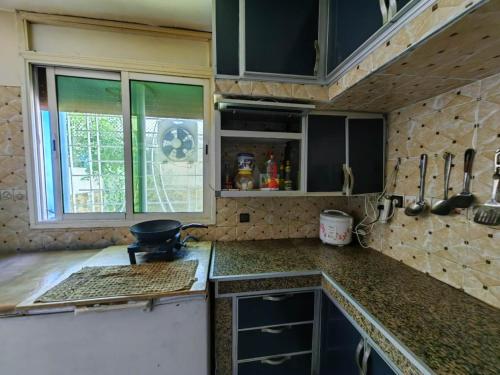 a kitchen with a stove and a counter top at MOHAMMED AIRPORT LUXURY VILLA in Deroua