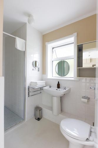 a bathroom with a toilet and a sink and a shower at Lios Na Manach ECO B&B in Killarney