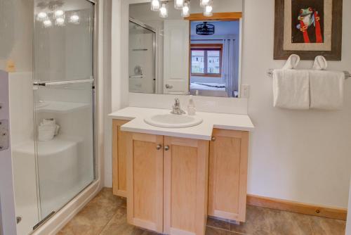 a bathroom with a sink and a shower at Modern Nordic 2 Bedroom Mountain View Condo in Canmore