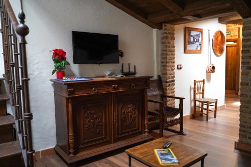 a living room with a television on top of a cabinet at La casa de la abuela Amalia in Arenas de San Pedro