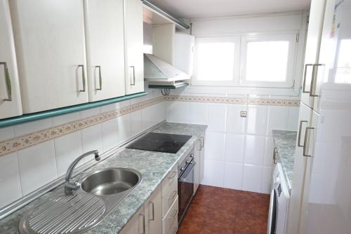 a kitchen with a sink and a counter top at Gran apartamento en primera línea Motril in Motril