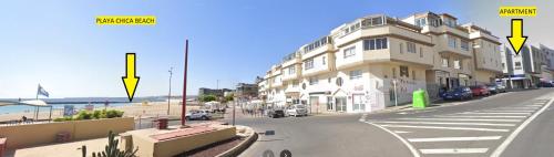 a view of a street with a building and the beach at 2V LUXURY APARTMENT NEAR BEACH in Puerto del Rosario