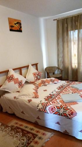 a bedroom with a bed with a laptop on it at SC Pati-Com FLOREX SRL - CASA ADELA in Tulcea