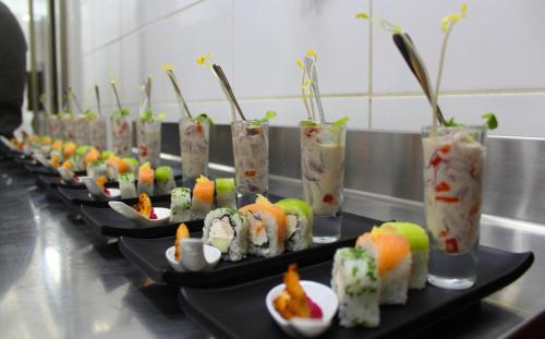 a row of plates of sushi on a table at Nuevo Hotel Constitucion in Constitución